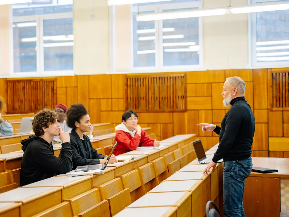 Lecturer speaking to students in a seminar room