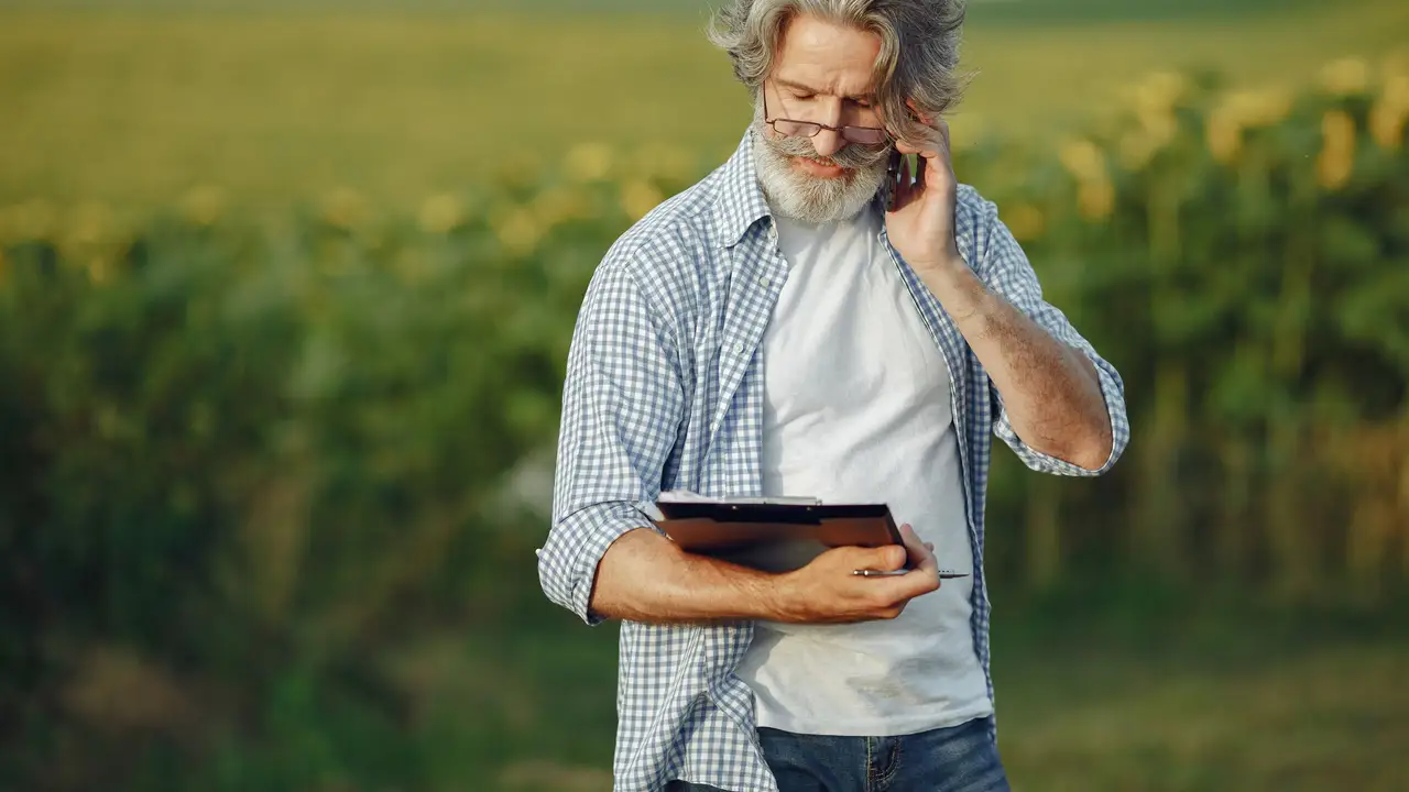 Agronomist reviewing crop data on a tablet in a field
