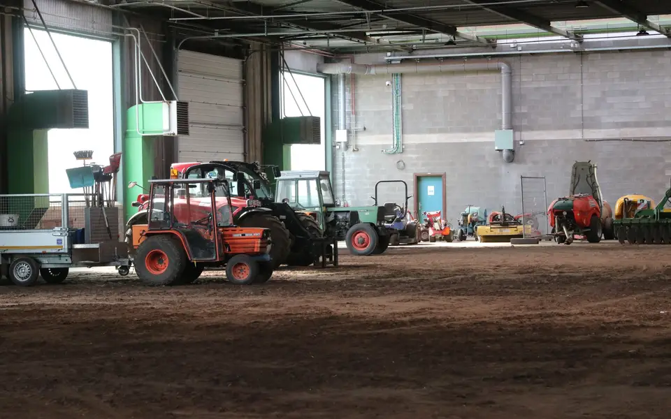 Tractor and farm equipment in a dealership yard
