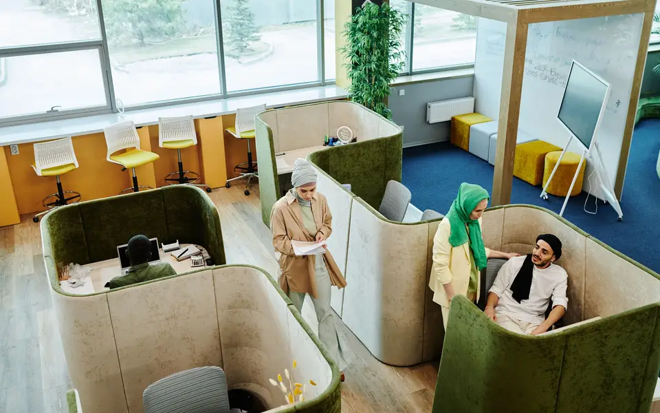 Coworking lounge with laptops and plants