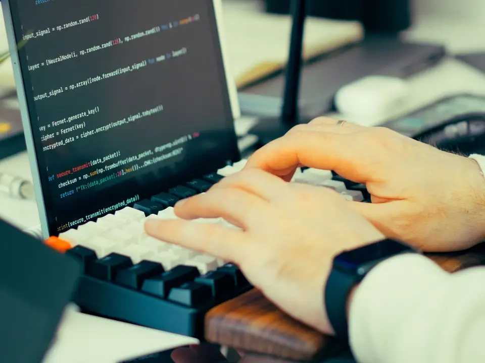 Developer typing scripts with code visible on screen