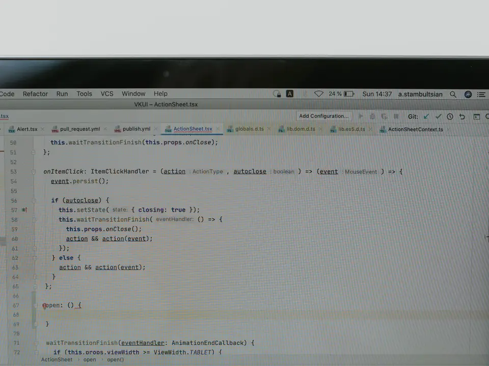 Hands typing code on a laptop keyboard
