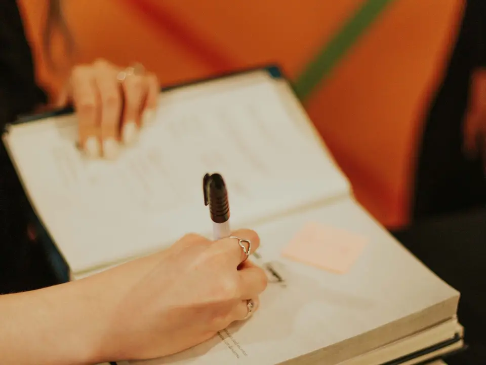 Author signing a copy of her book