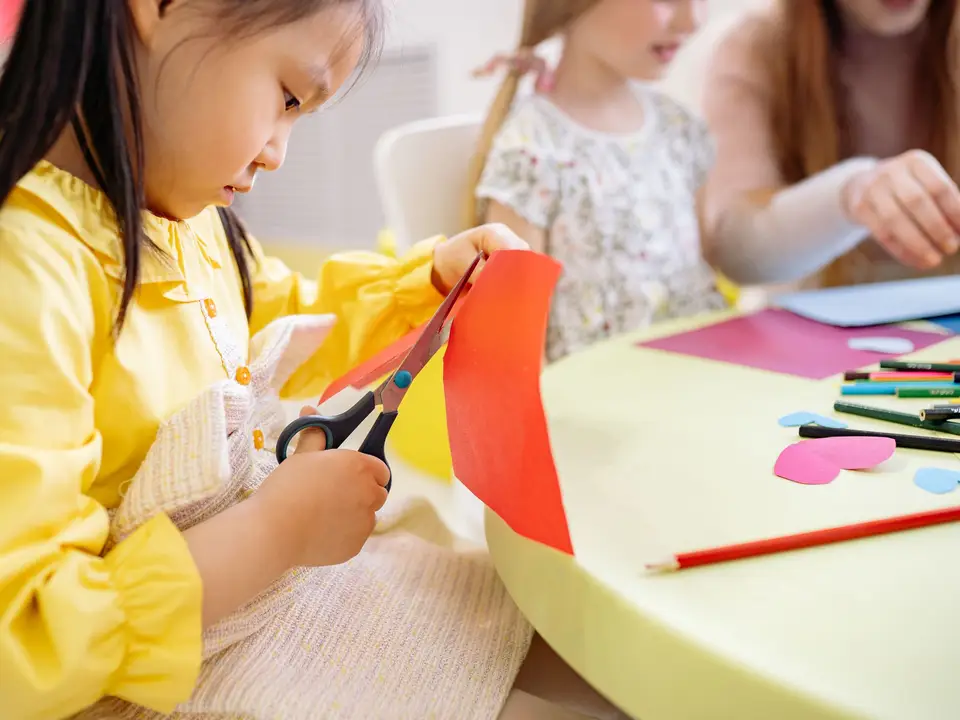 Child focused on reading at a table