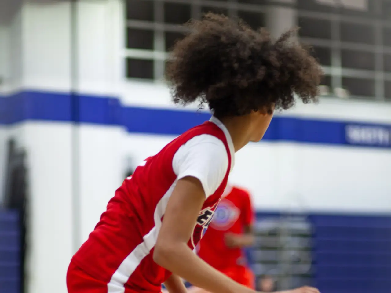 Basketball player shooting on an indoor court