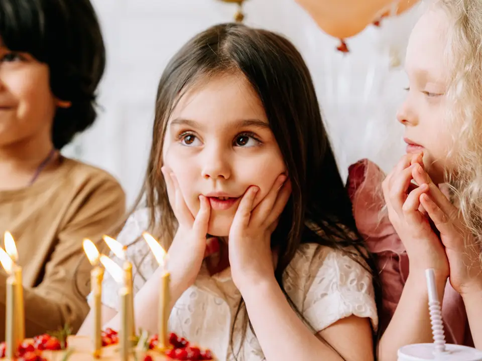 Children round a birthday table