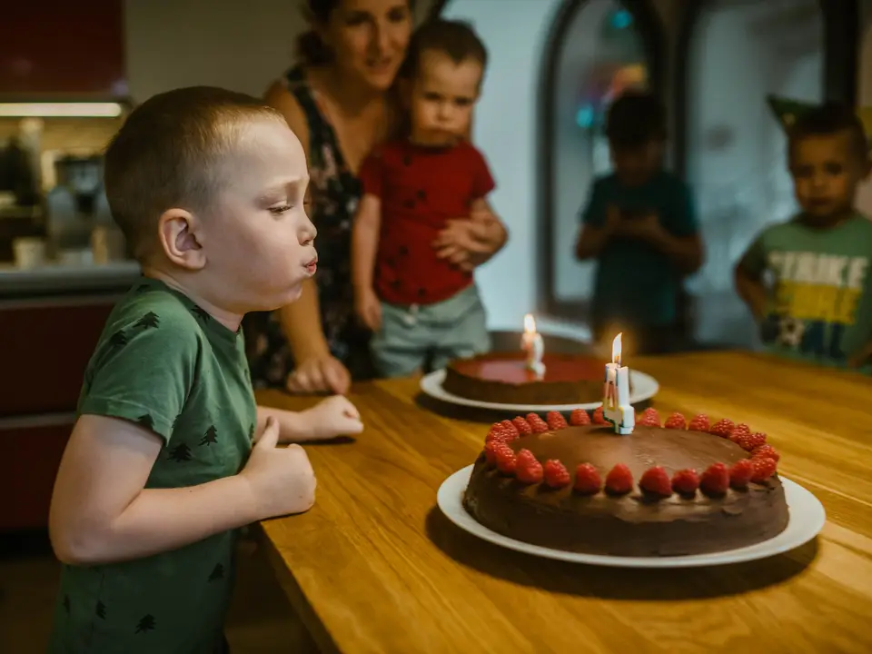 Boy blowing out candles