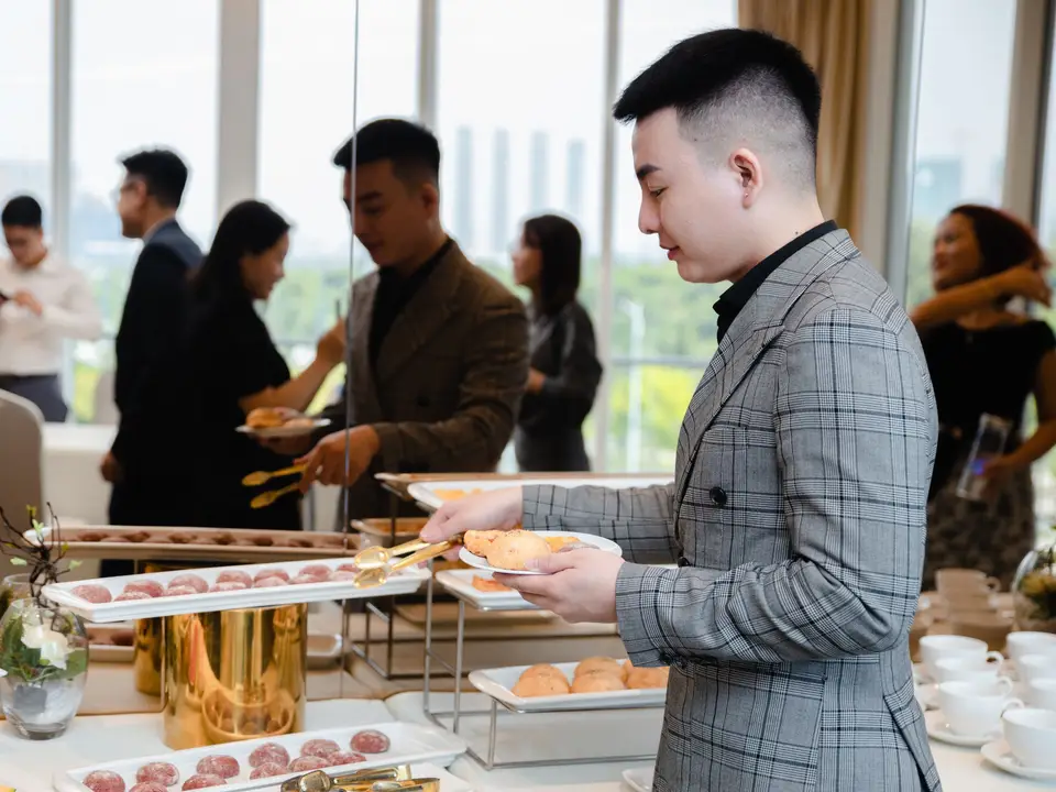 Professionals mingling at a business networking event with a buffet