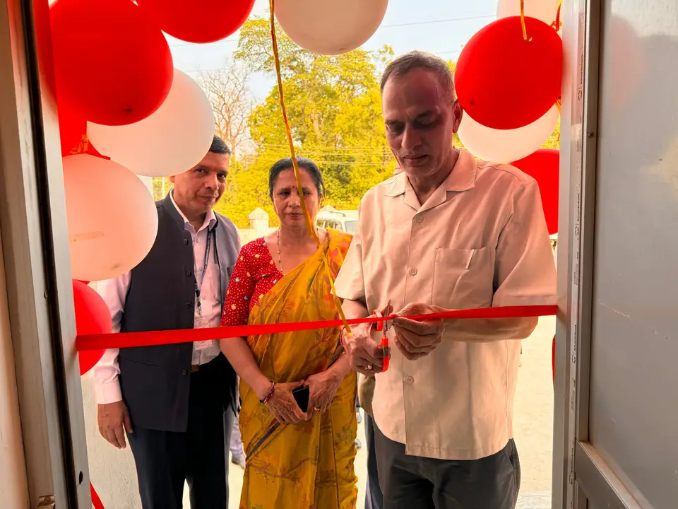 Ribbon cutting at a shop entrance decorated with balloons