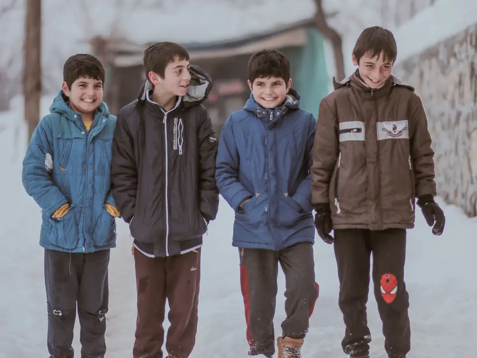 Children walking to school in donated winter coats