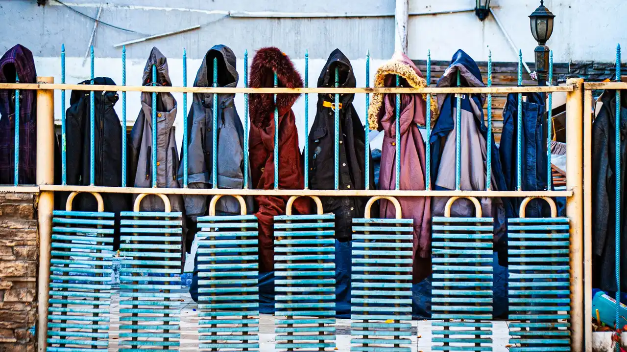 Racks of warm winter jackets organized by size