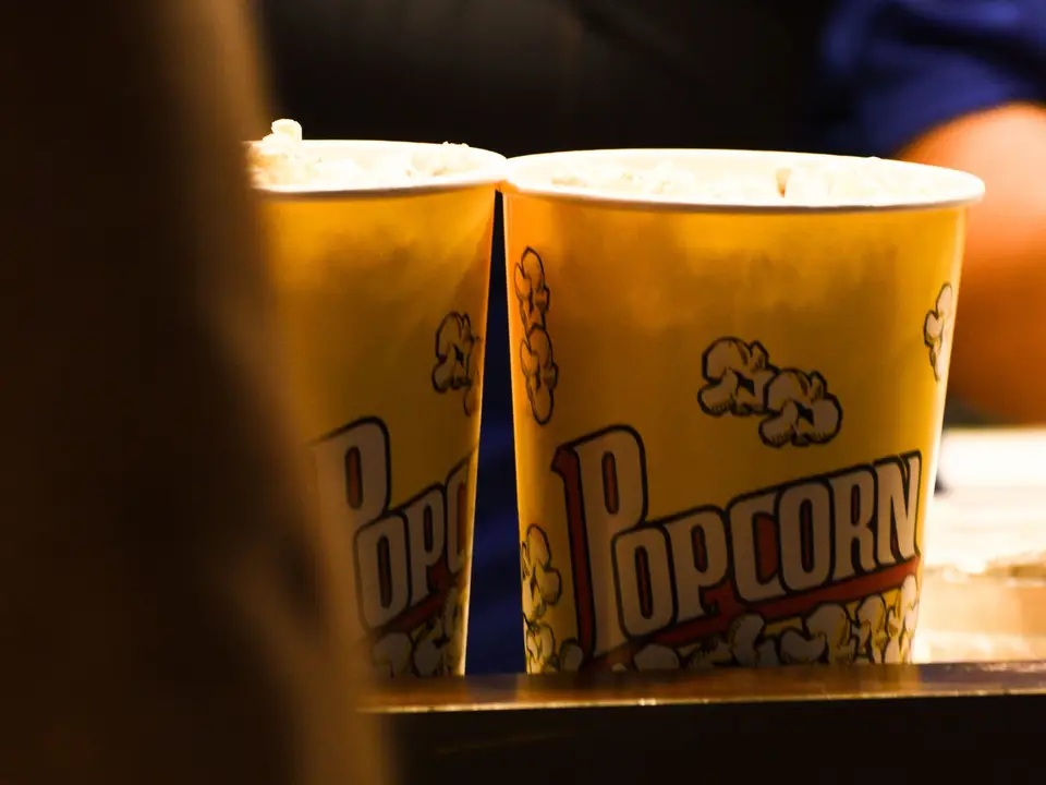 Popcorn buckets lit on a movie theater concession counter