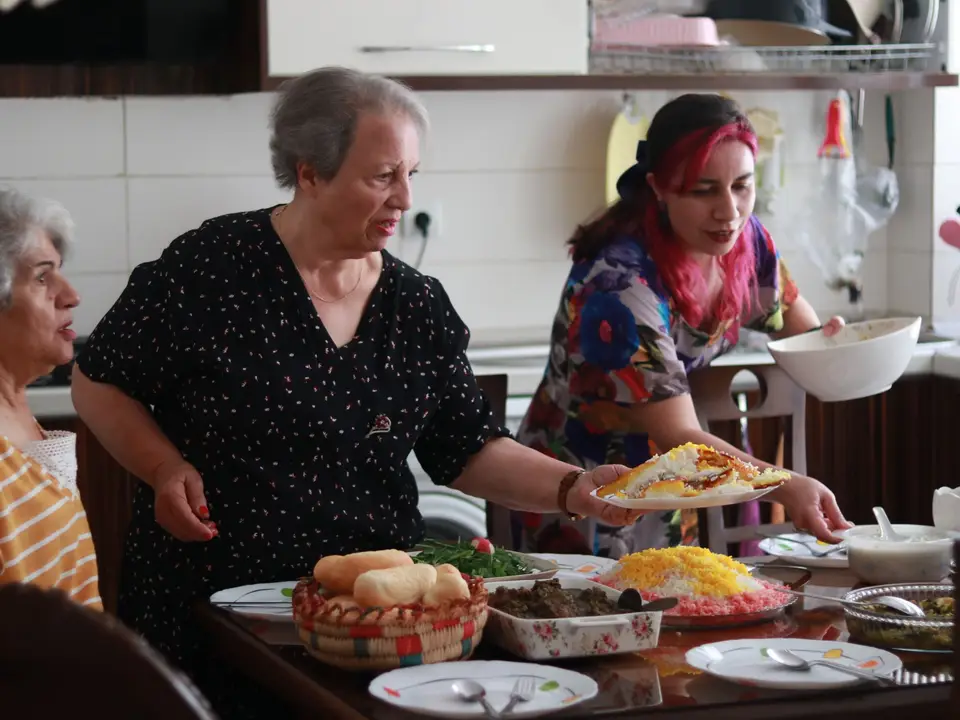 Older women sharing a home-cooked meal around a table