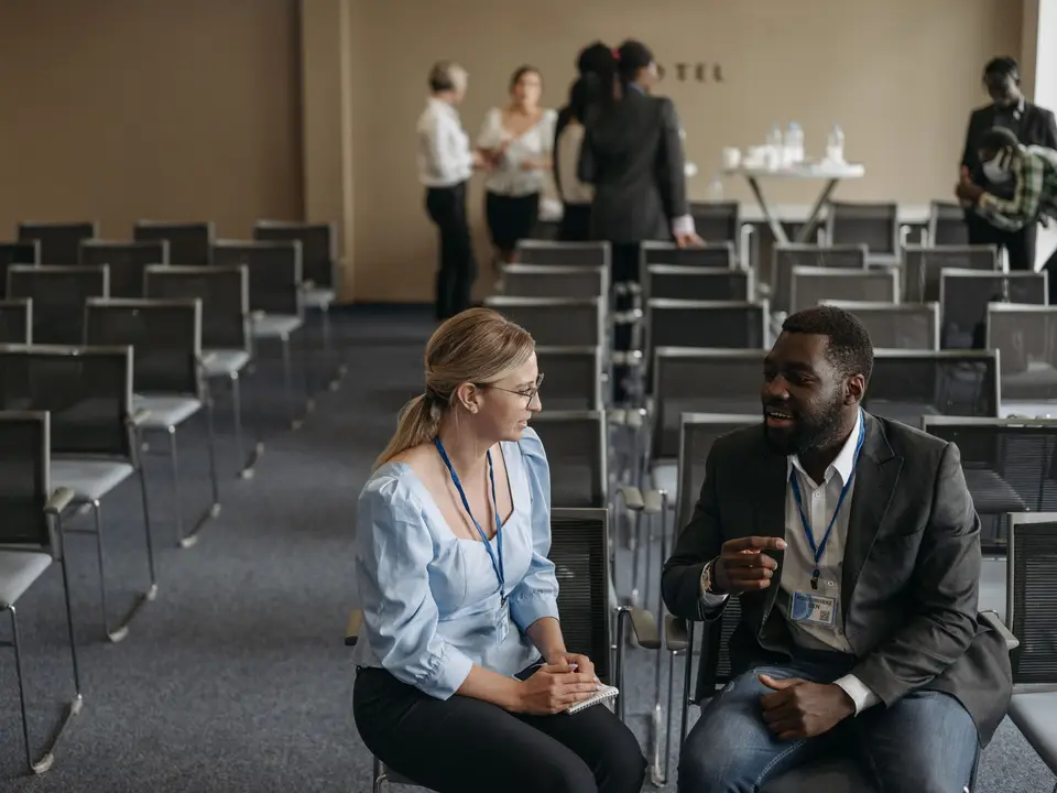 Two attendees talking between sessions
