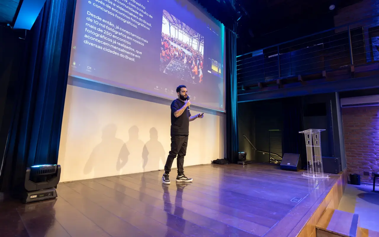 Speaker on stage in front of a slide