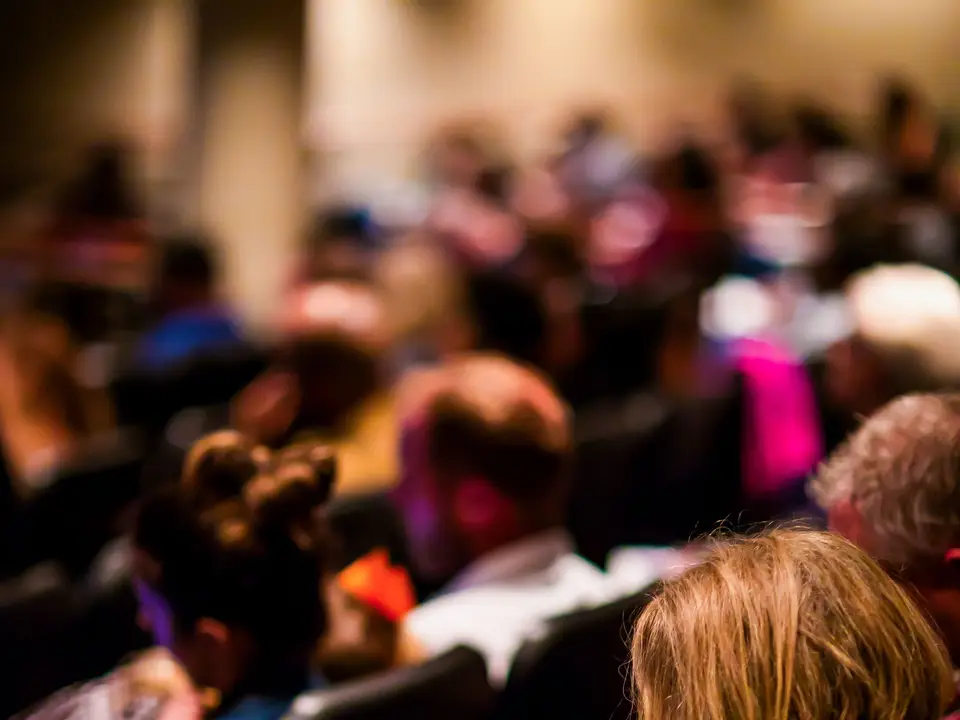 Audience watching a speaker at a lectern