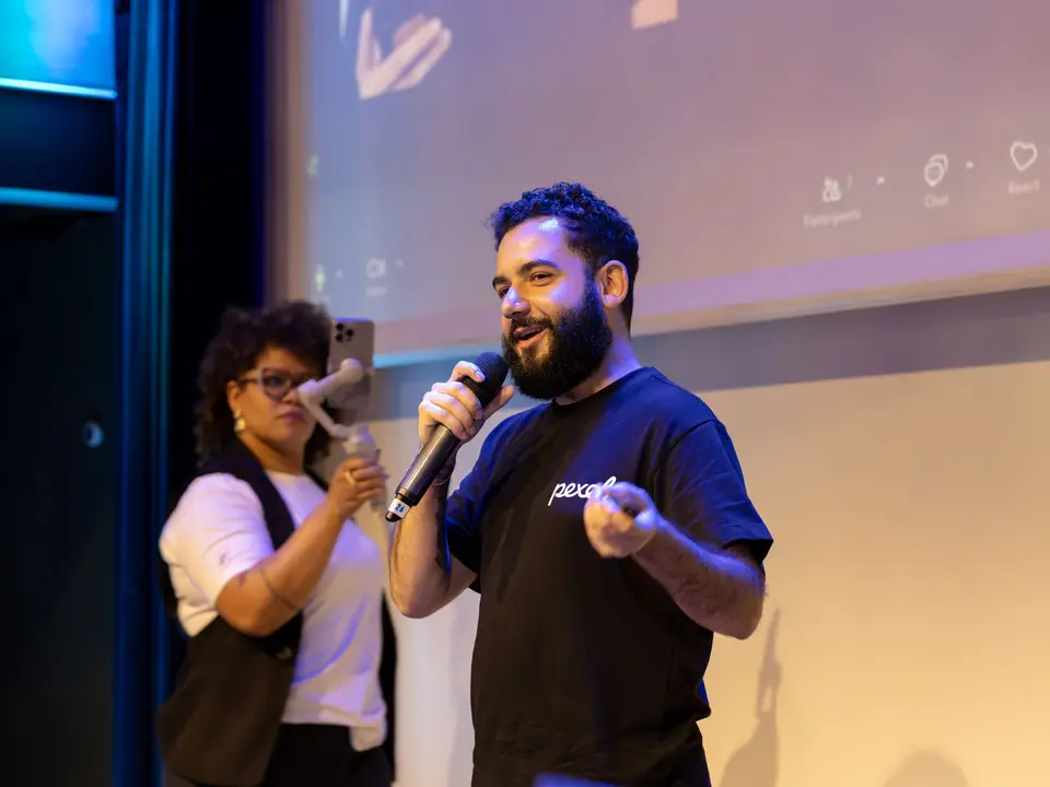 Presenter with a microphone on stage