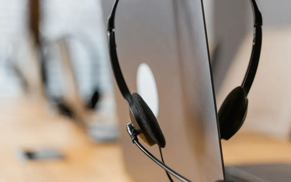 Small phone booth with laptop and headset