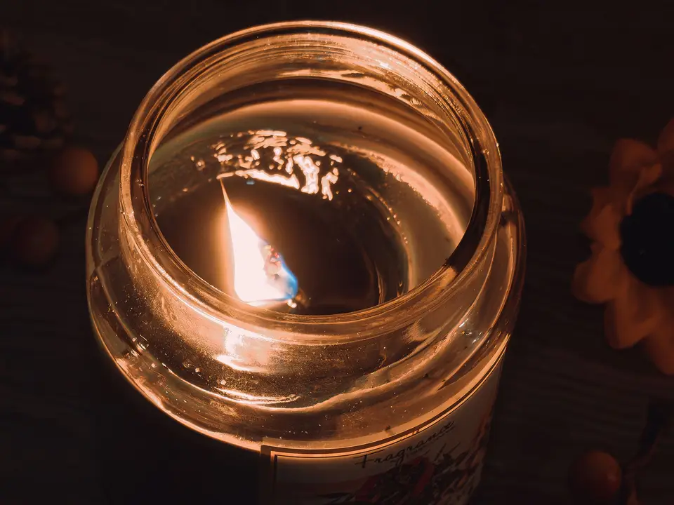 Family gathered around a glowing lantern in a home at night
