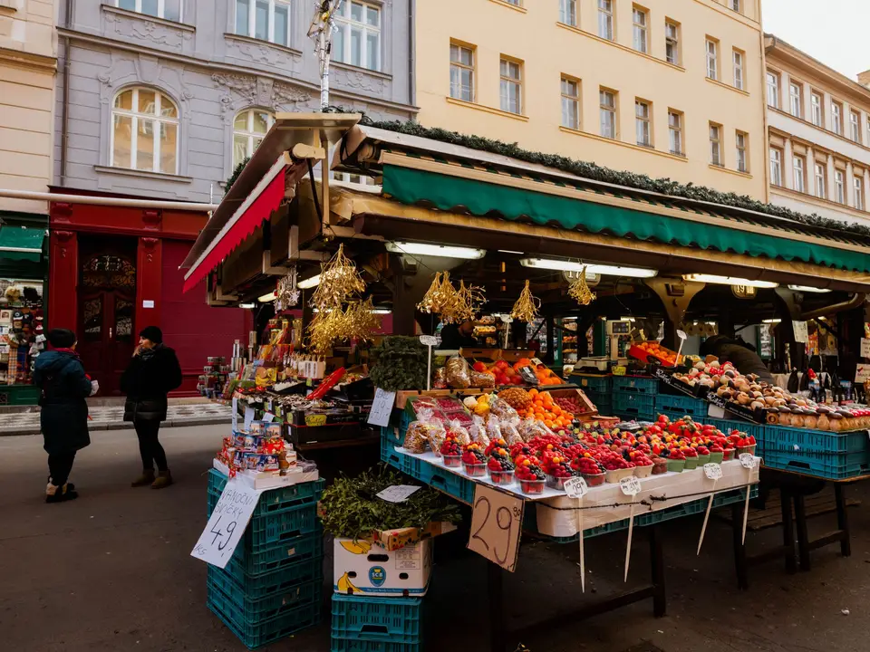 Outdoor market stall piled with fresh fruit and vegetables
