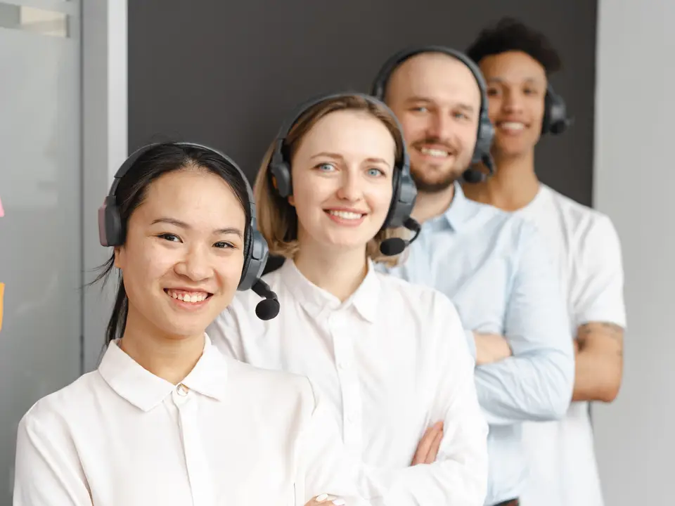 Smiling customer service team wearing headsets