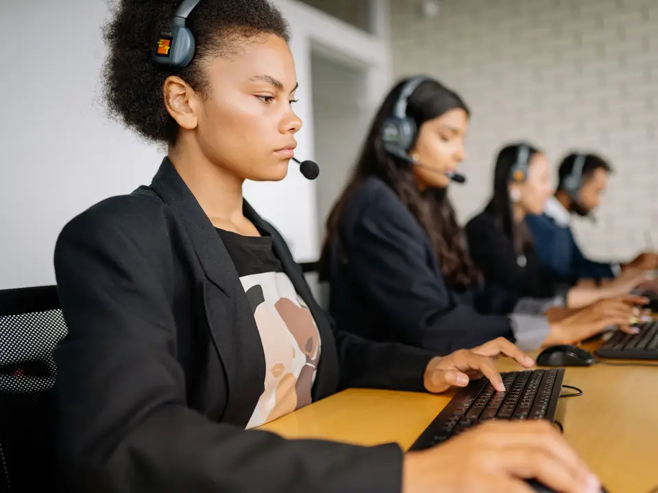 Support team working with headsets and computers