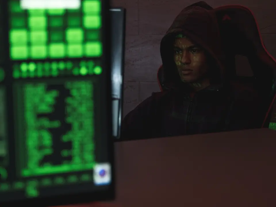 Security analyst reviewing threat alerts on dual monitors