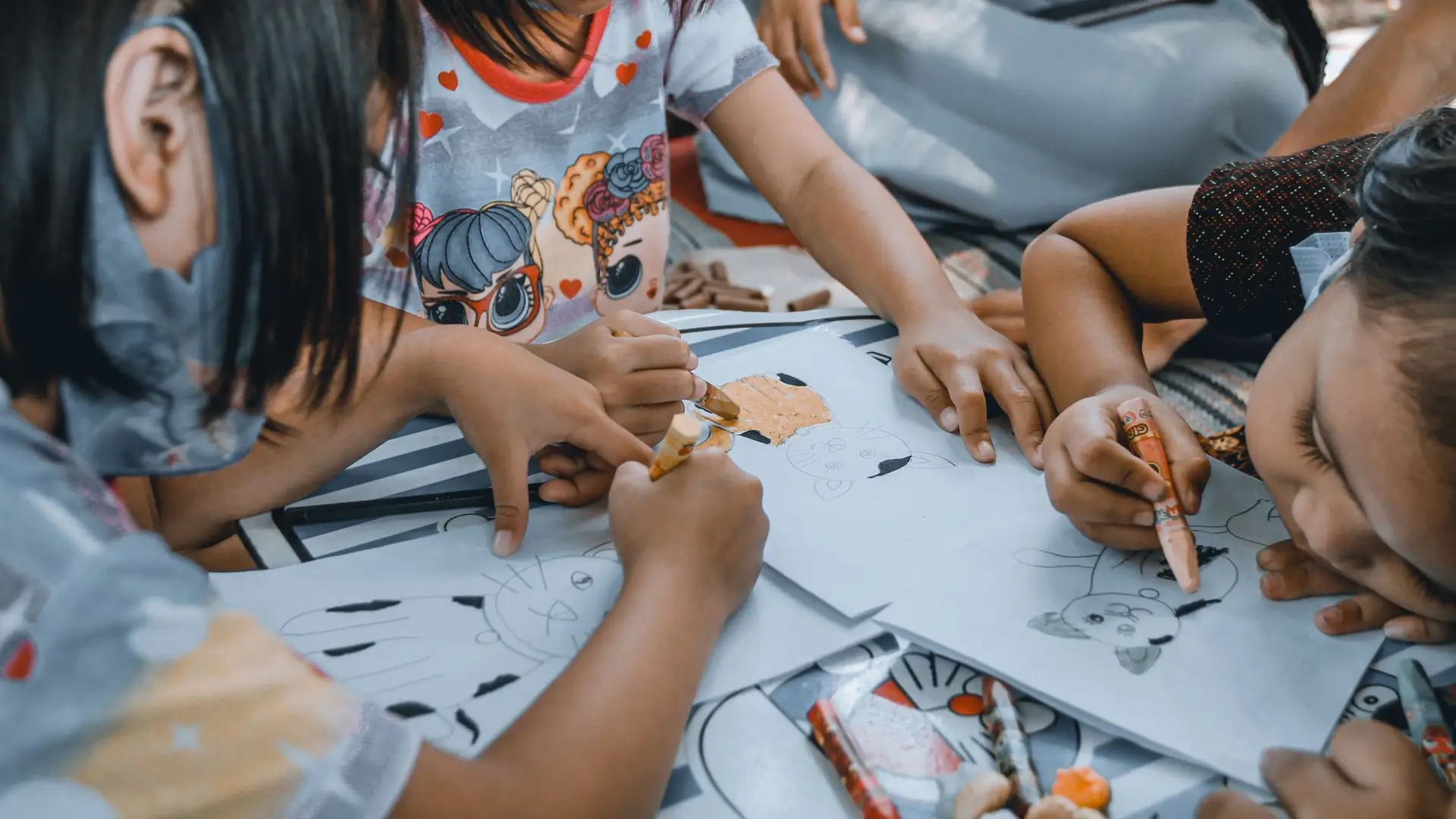 Preschool children drawing together at a table