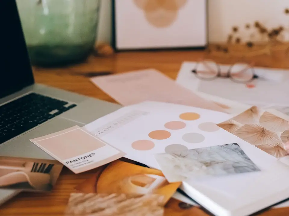 Printed brand sheets on a studio desk