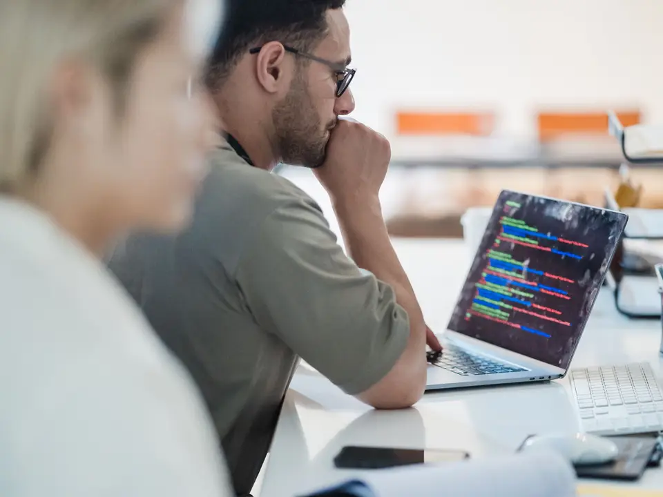 Two developers working together on a coding project