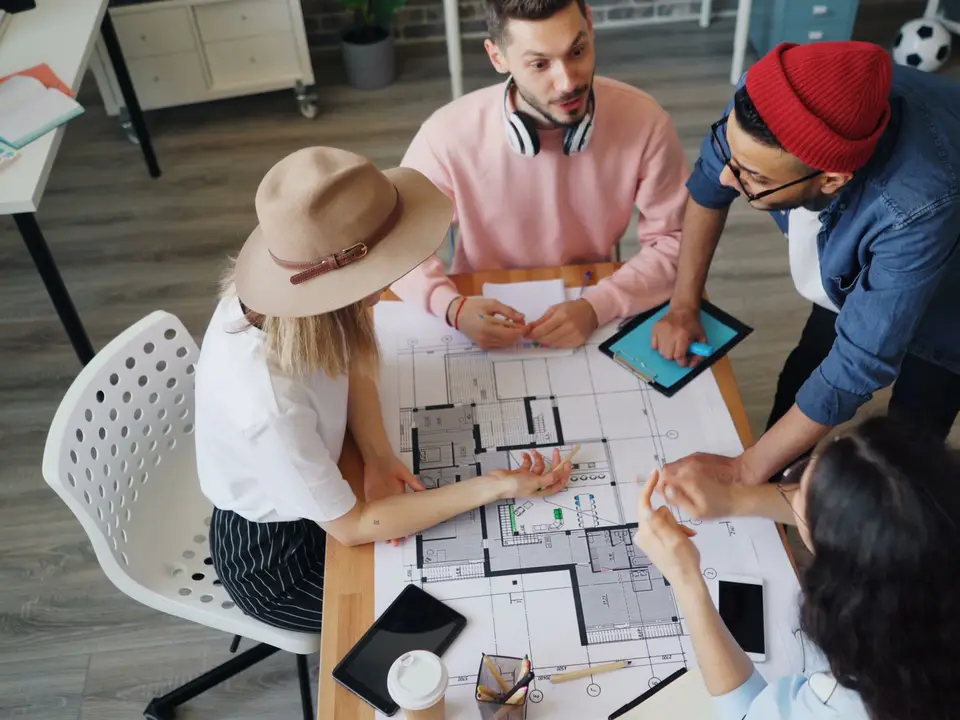 Multiethnic team of designers discussing plans in a modern office
