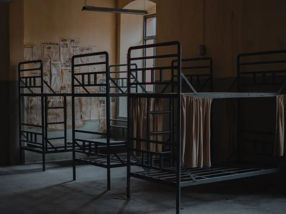 Rows of bunk beds ready in an emergency shelter dormitory