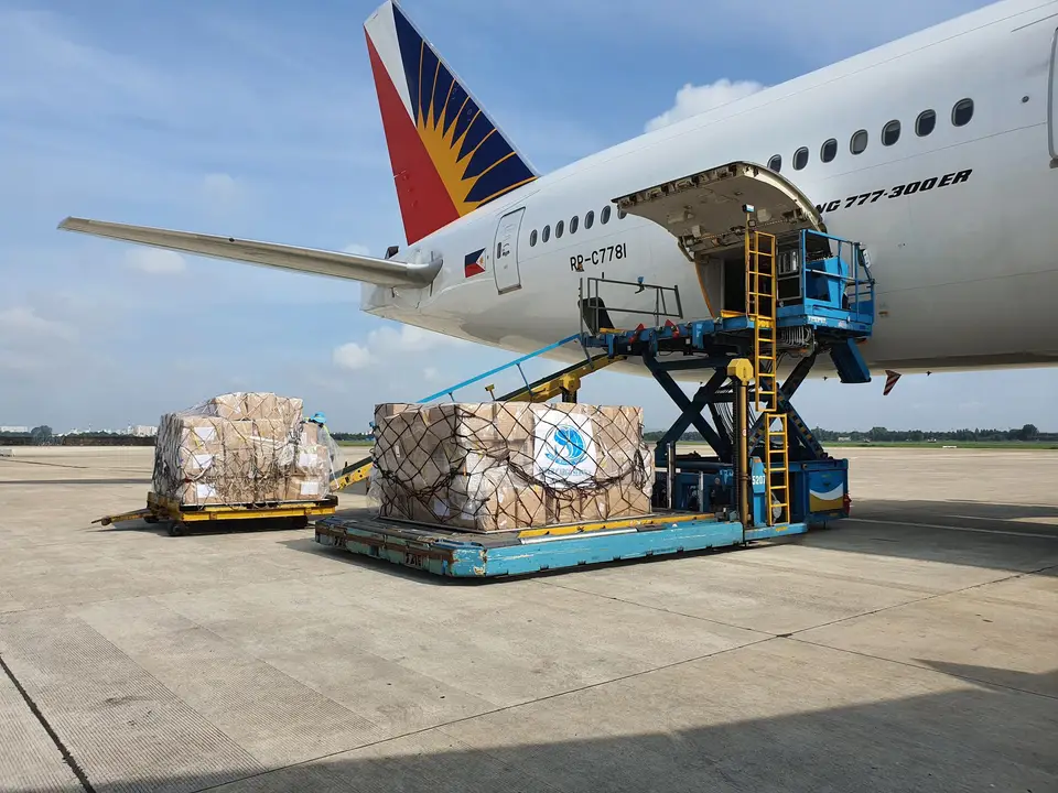 Cargo crew loading pallets onto an airplane