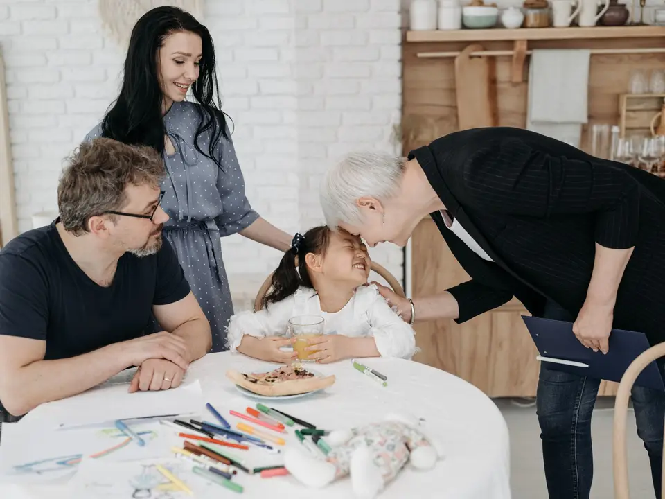 Social worker meeting with a family at a table indoors