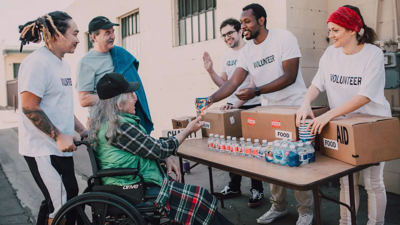 Relief volunteers handing out bottled water and supplies