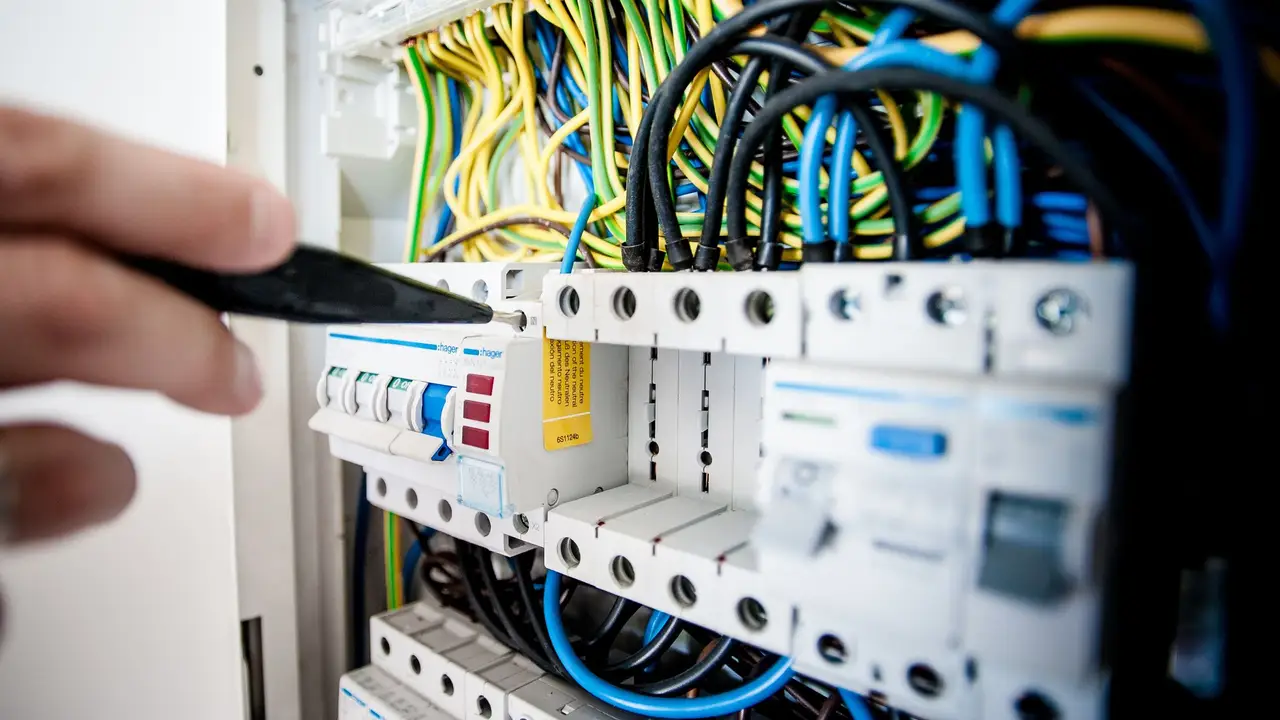 Electrician labeling breakers in a freshly installed panel