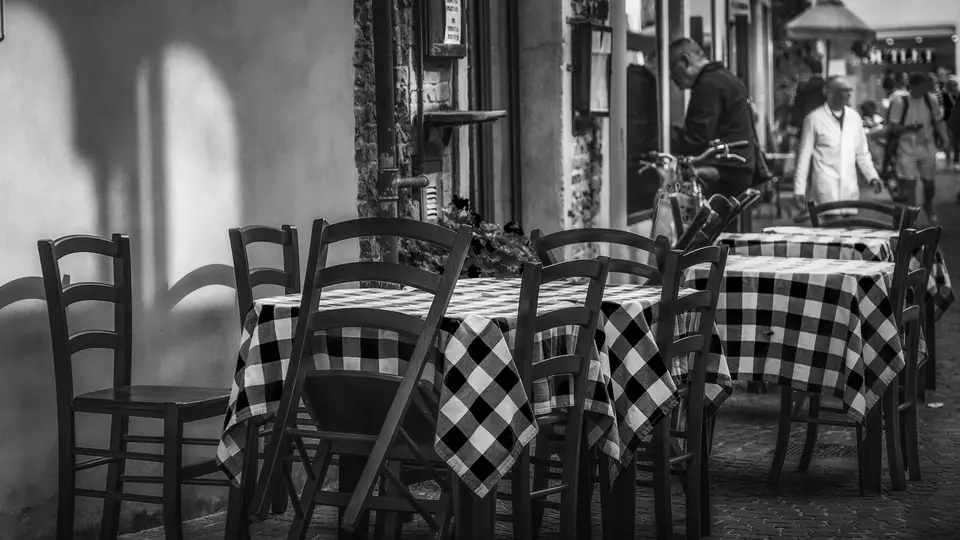 Outdoor café tables on a cobbled yard