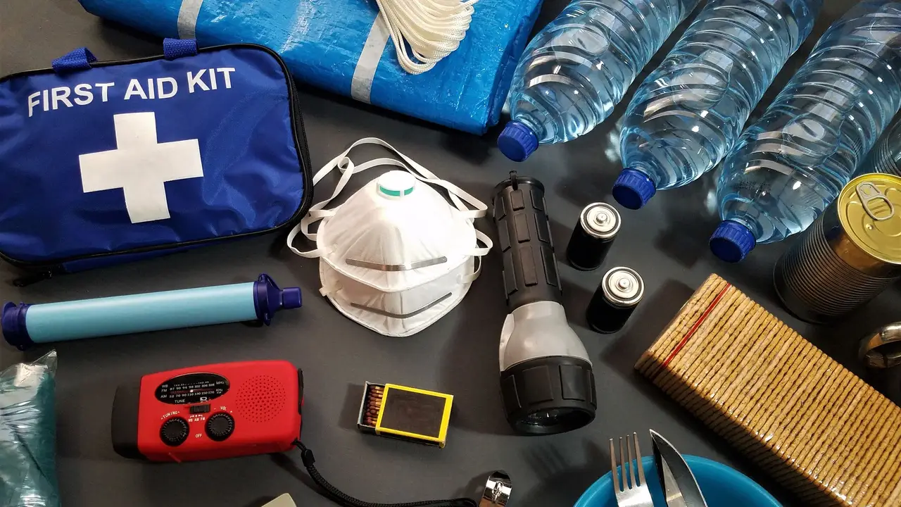 Emergency kit with first aid, water, torch and radio laid out