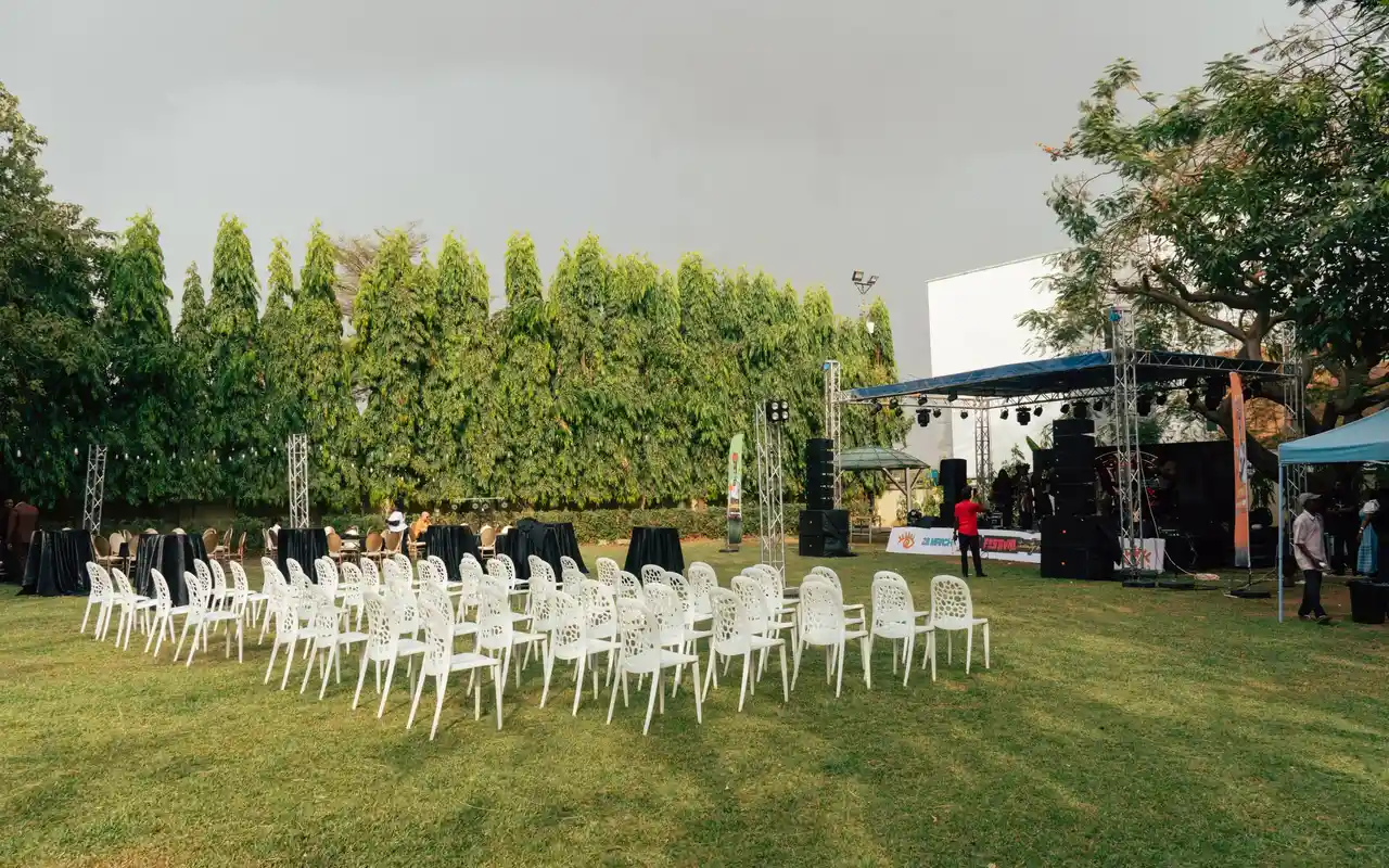 Outdoor event set with chairs facing a stage