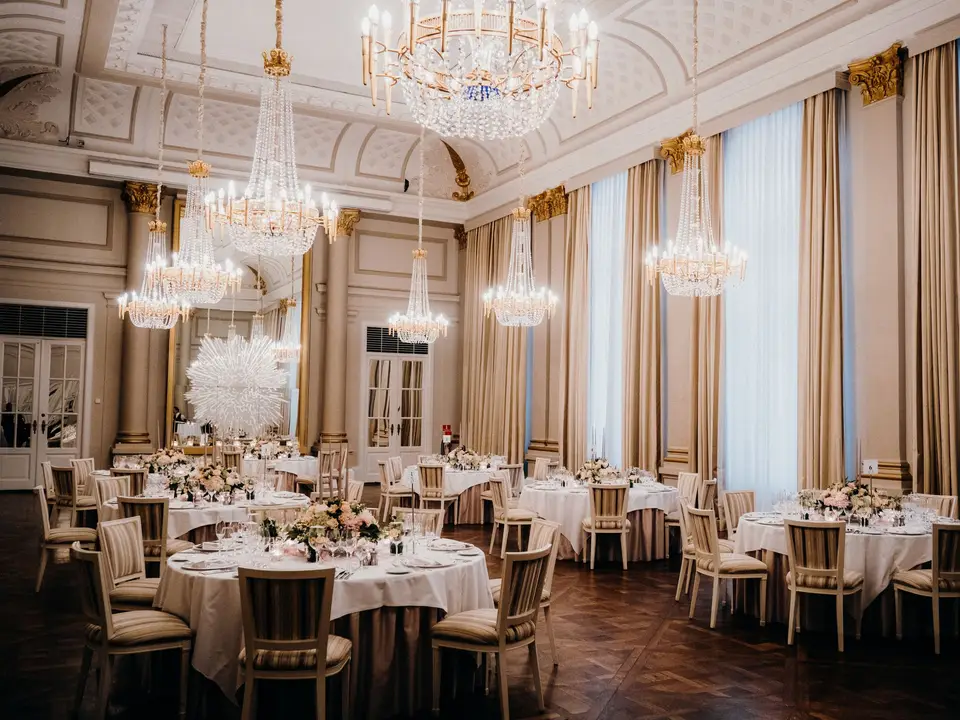 Ballroom tables under chandeliers