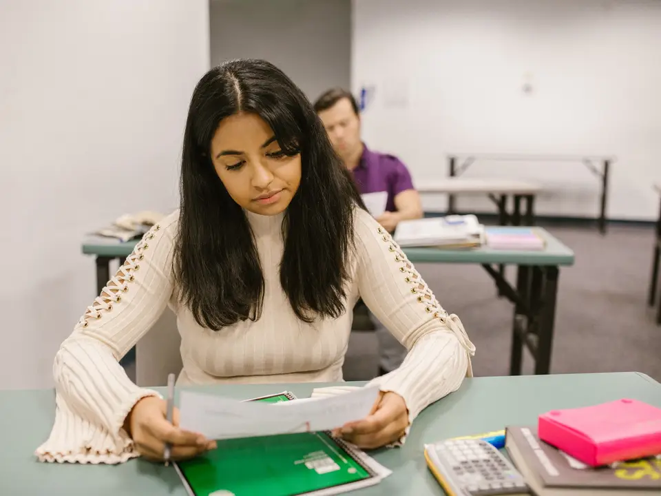 Student looking at her exam results in a classroom