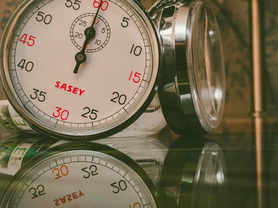Classic analog stopwatch on a glass surface
