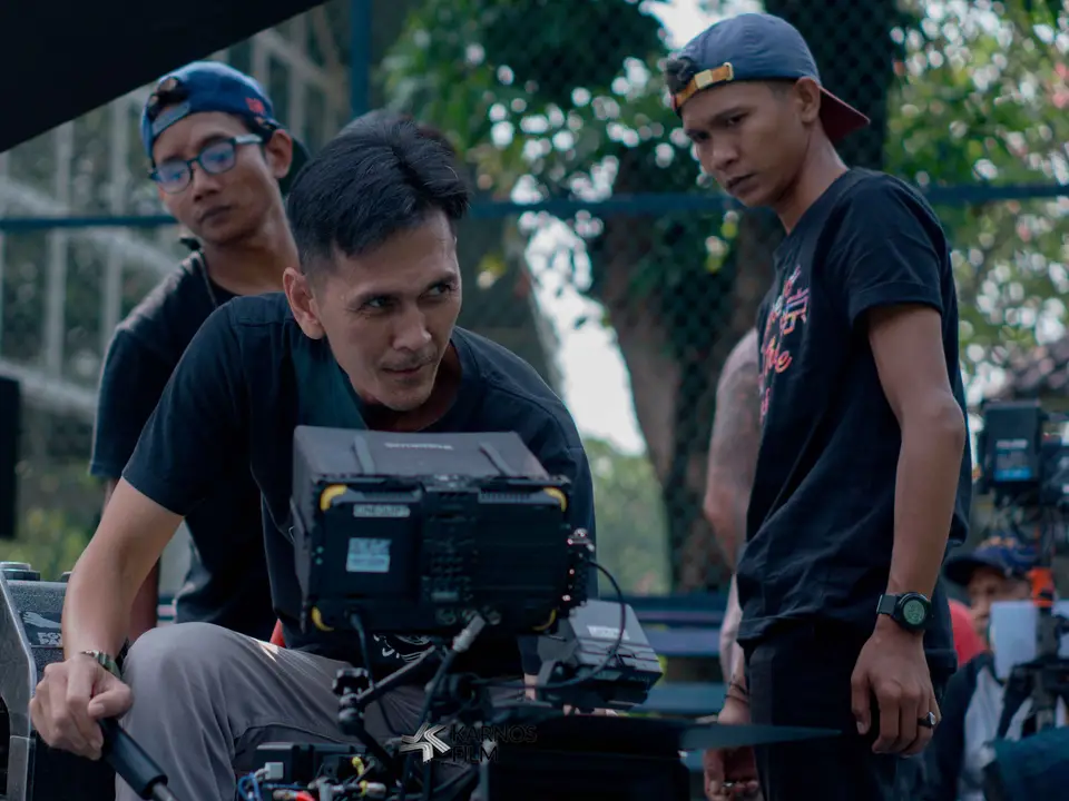 Filmmakers checking footage on a camera monitor outdoors