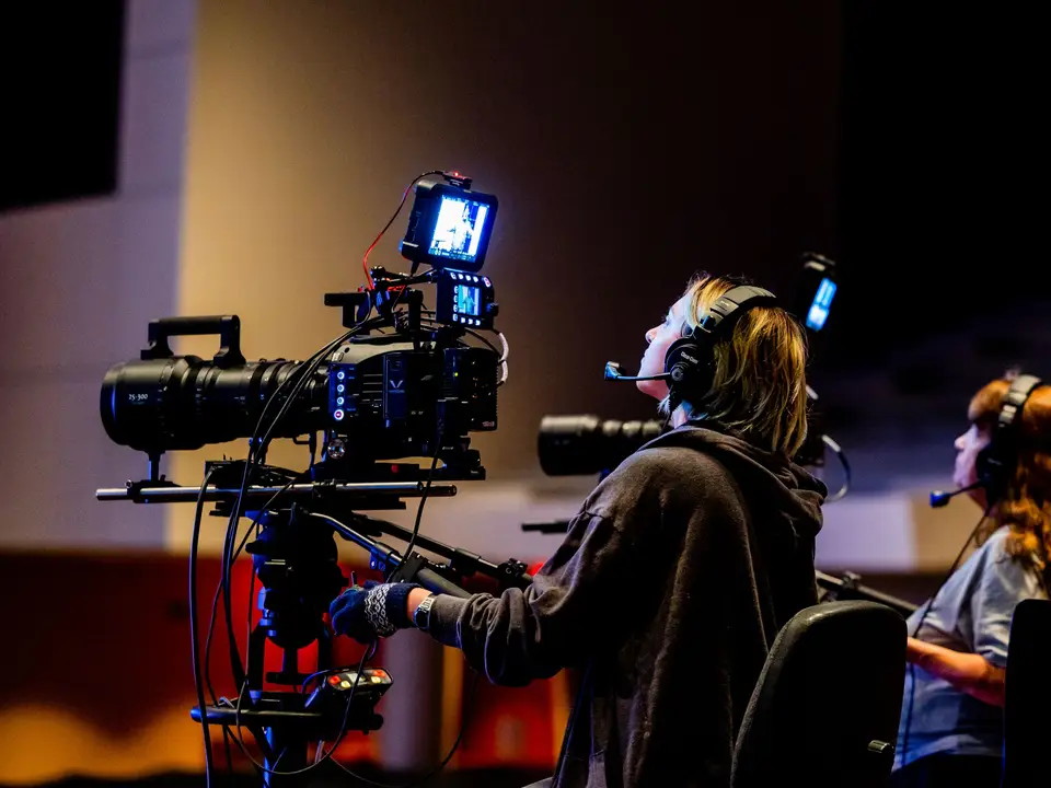 Camera rig and crew in a dark studio during the Porchlight shoot