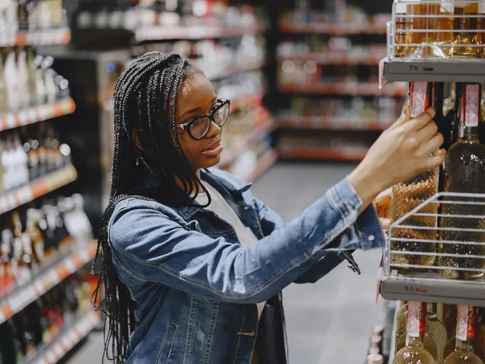 Client choosing groceries from stocked shelves