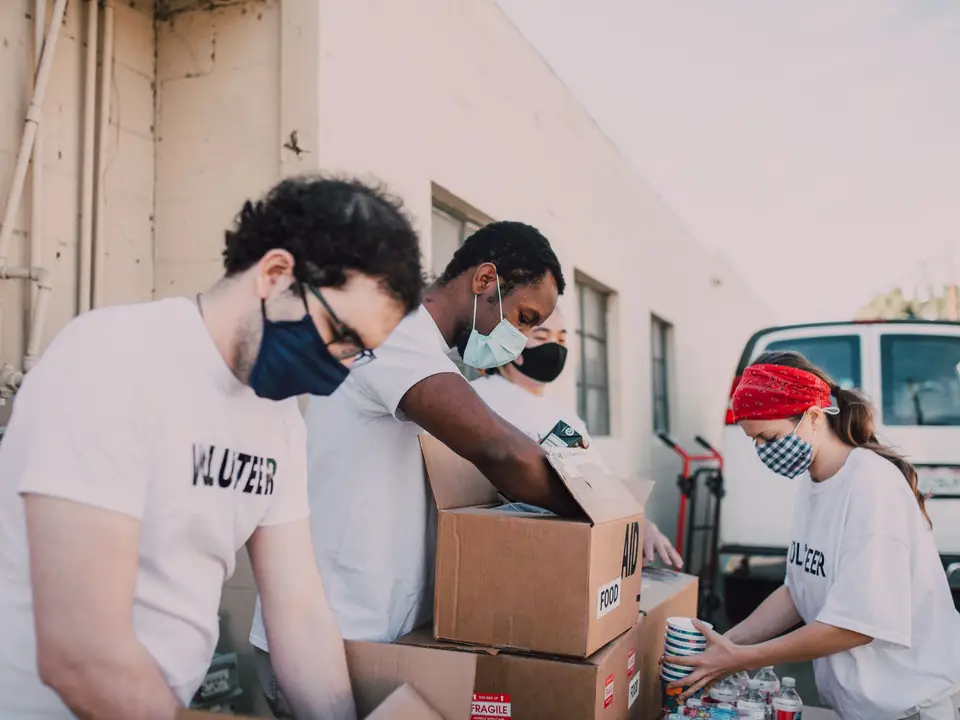 Volunteers packing food boxes for weekend distribution