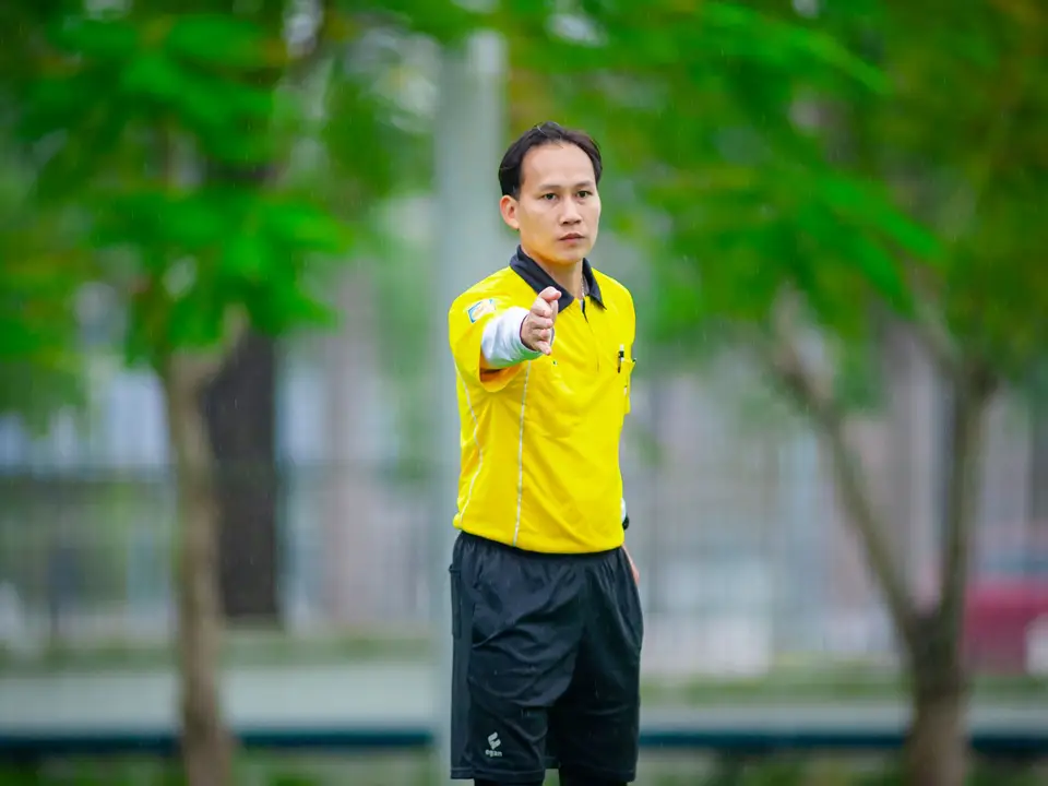 Referee whistle and yellow card on a football pitch