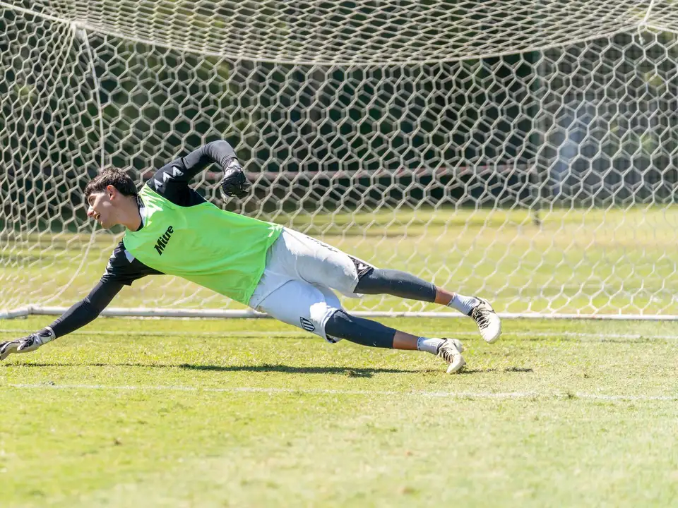 Goalkeeper diving to save a football