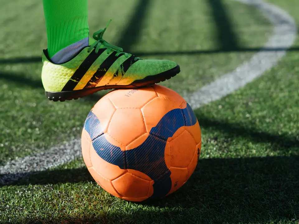 Close-up of a football on green artificial turf