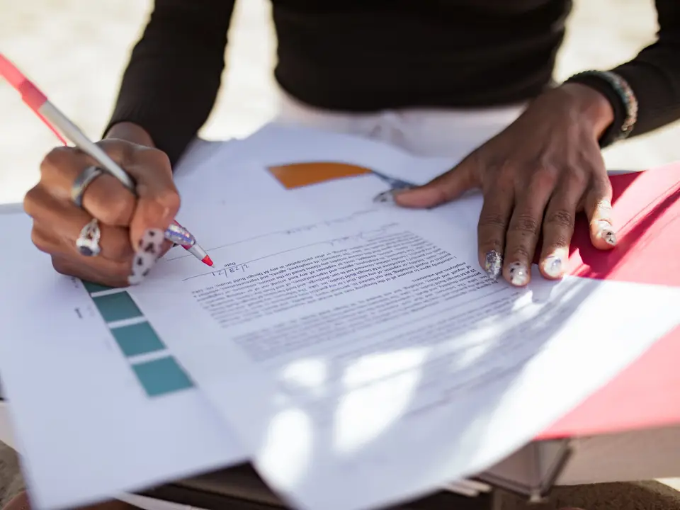 Red pen marking edits on a printed draft